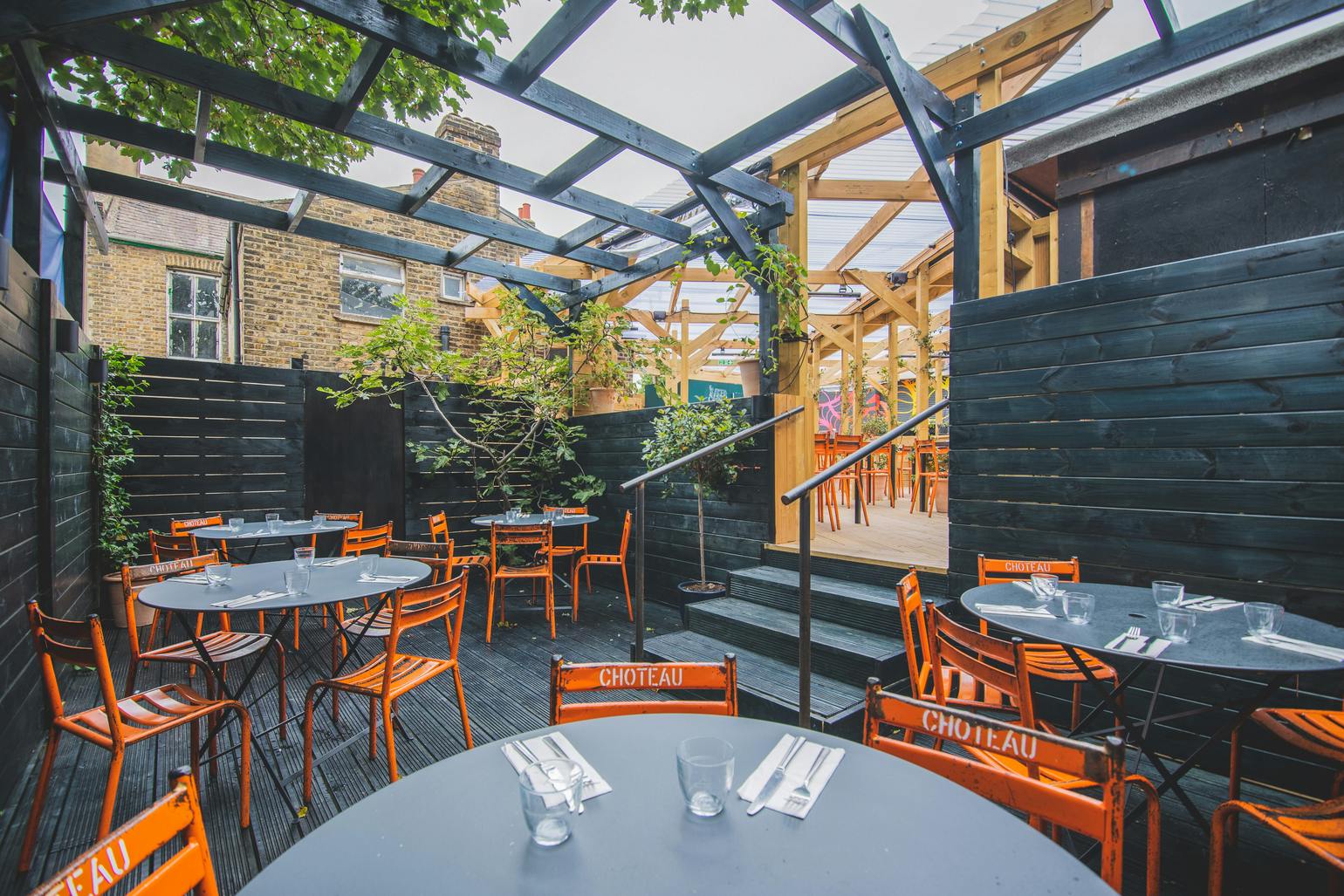 Sunken Garden in Mike's Peckham: vibrant outdoor event space with modern tables and chairs.