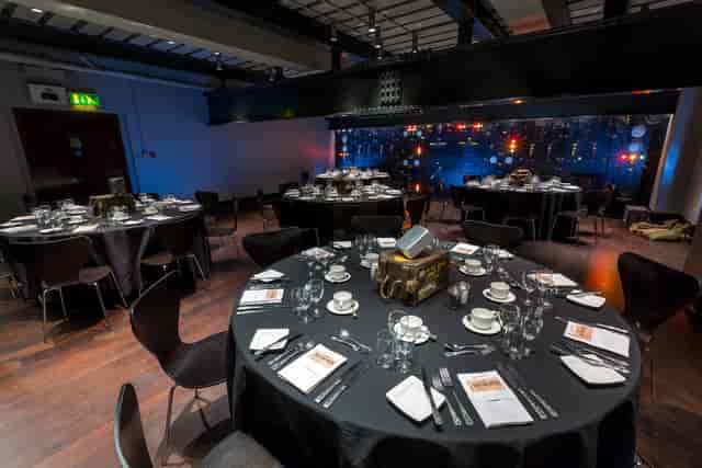 Harmsworth Room set for formal dinner, elegant tables, corporate event venue.