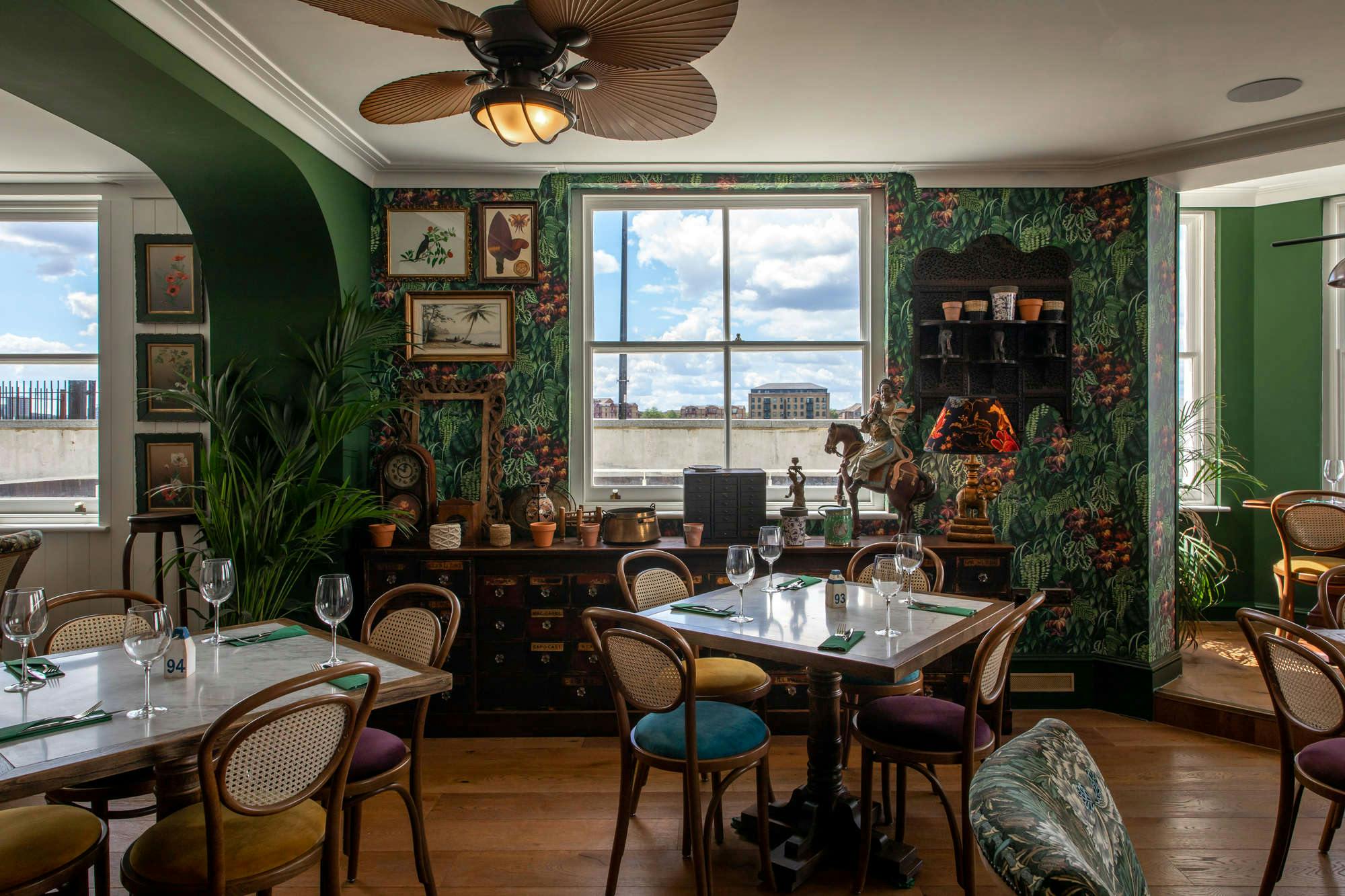 Charming dining space with lush greenery for intimate meetings and events at Enderby House.