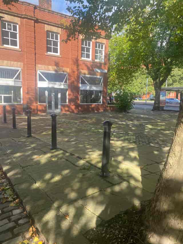 Outdoor space at Albert Bentley Place, ideal for events and gatherings with tree shadows.
