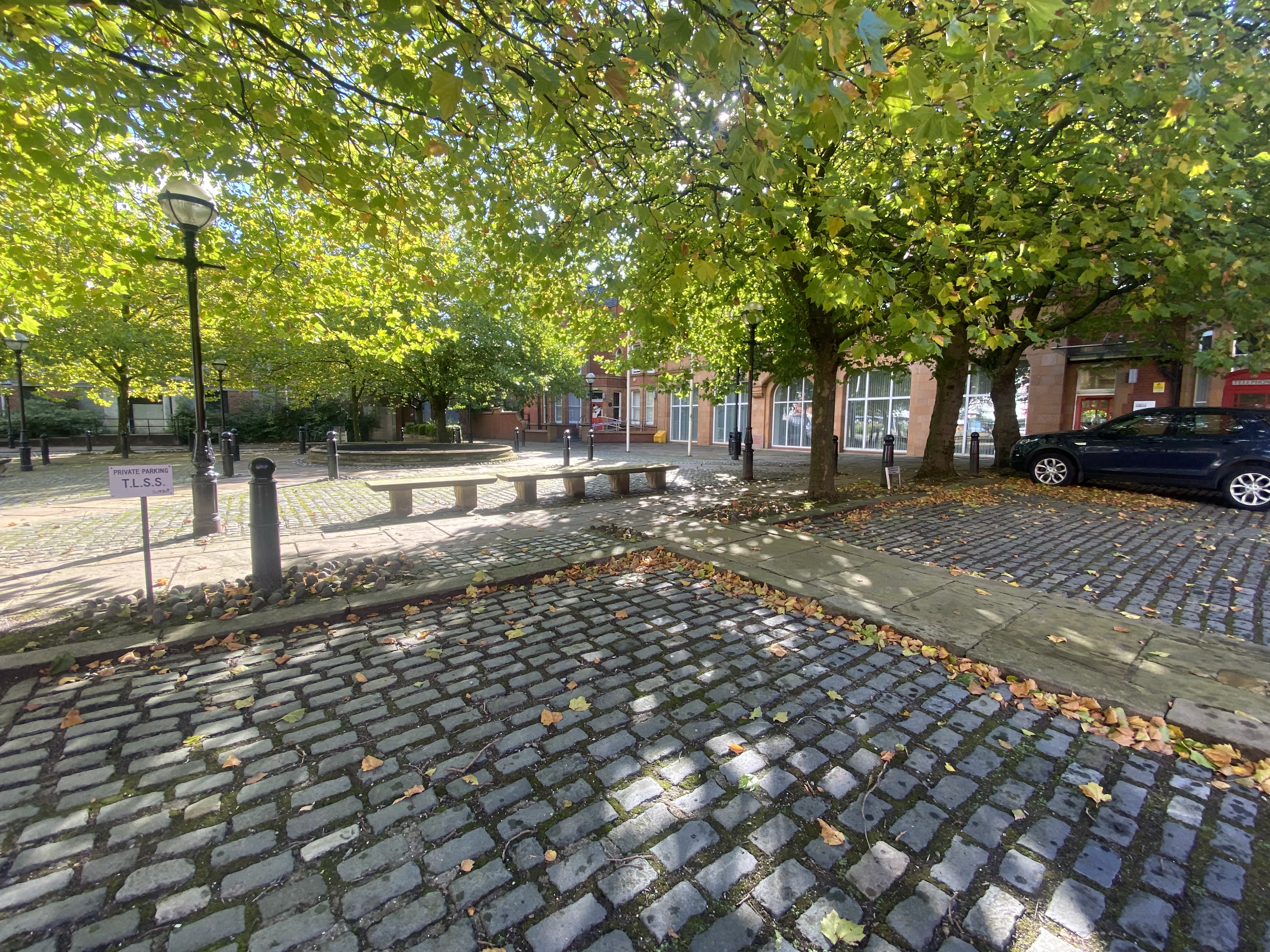 Serene outdoor meeting space at Albert Bentley Place with cobblestone charm.