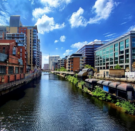 Vibrant Stanley Square venue with canal, ideal for outdoor networking events. - Banner