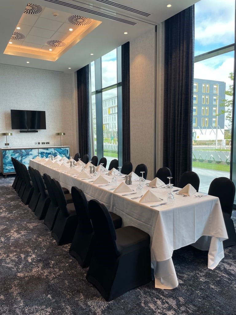 Stoneywood Suite meeting room with elegant dining setup for corporate events.