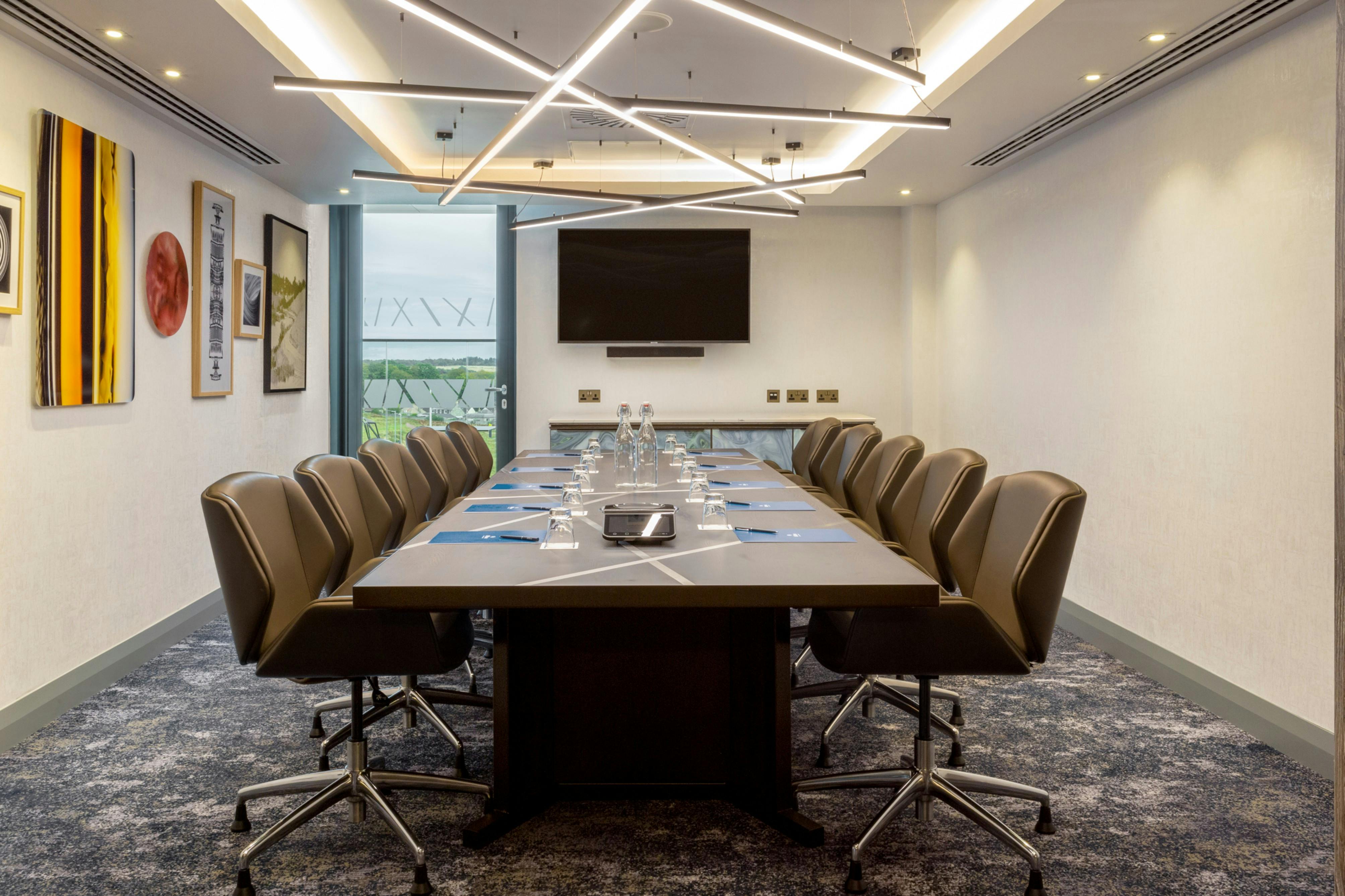 Modern conference room in Hilton Aberdeen TECA, featuring a sleek table for corporate events.