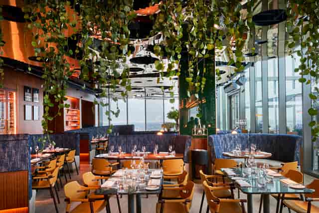 Upscale 20 Stories Restaurant with lush greenery, perfect for corporate dinners and events.