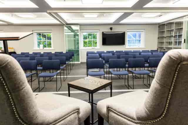 Third Floor Meeting space with blue chairs, ideal for presentations and panel discussions.