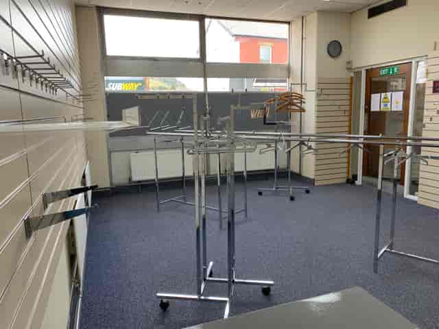Spacious Llani Pop Up area with clothing racks for event check-in and wardrobe management.