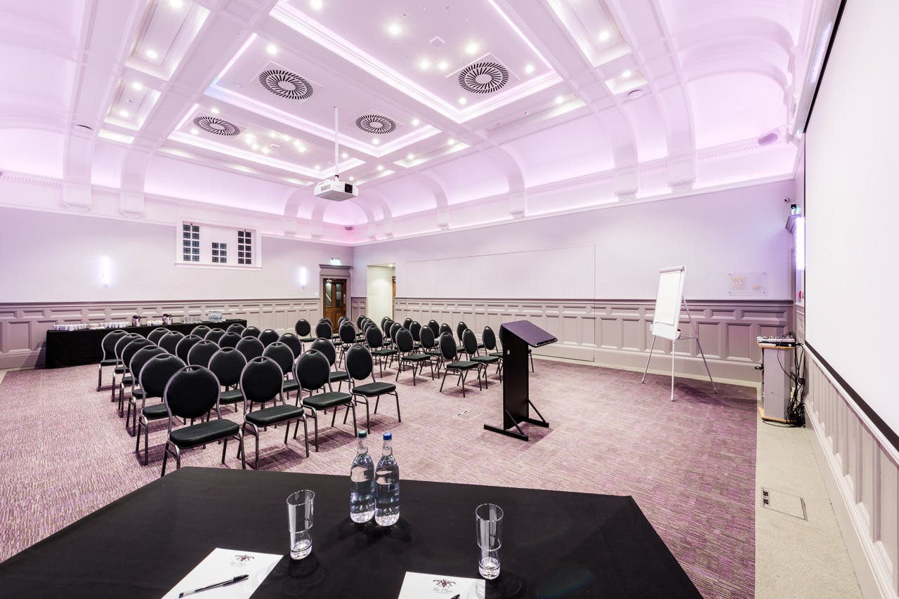 Meeting room at The Raeburn, featuring chairs and podium for workshops and presentations.