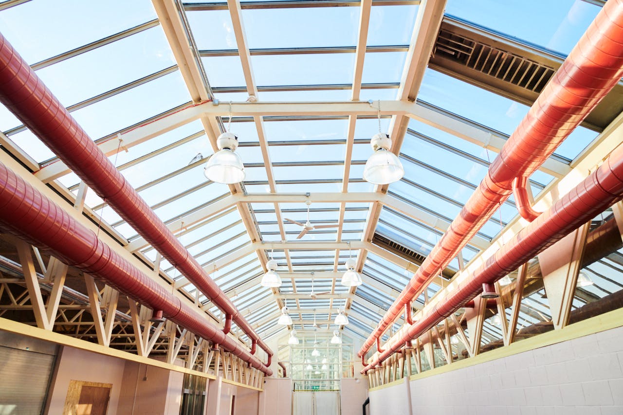 Hackney Depot Main Hall with modern glass roof, ideal for networking events and workshops.