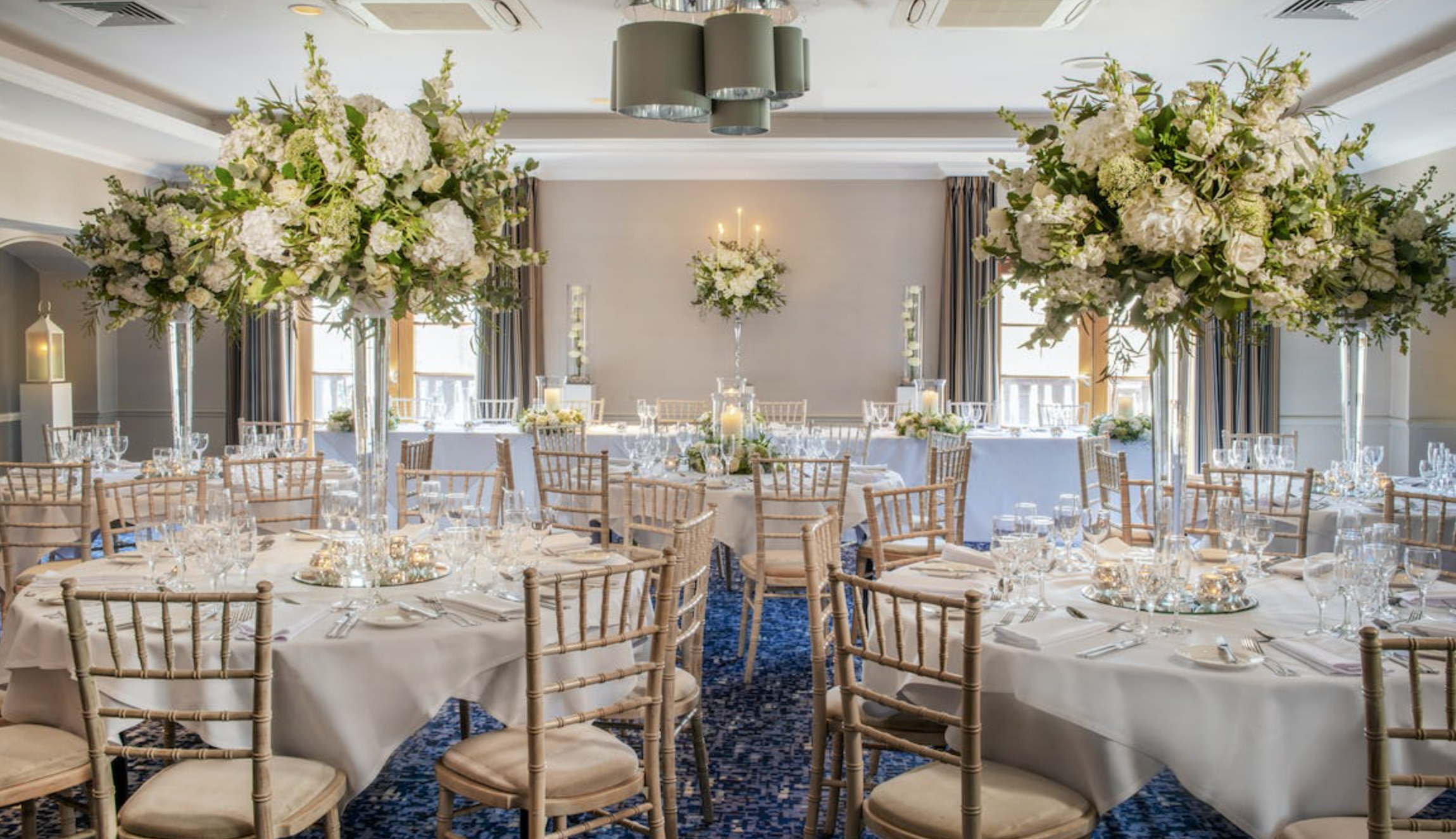 Elegant Hambledon suite with floral centerpieces, ideal for weddings and formal events. - Banner