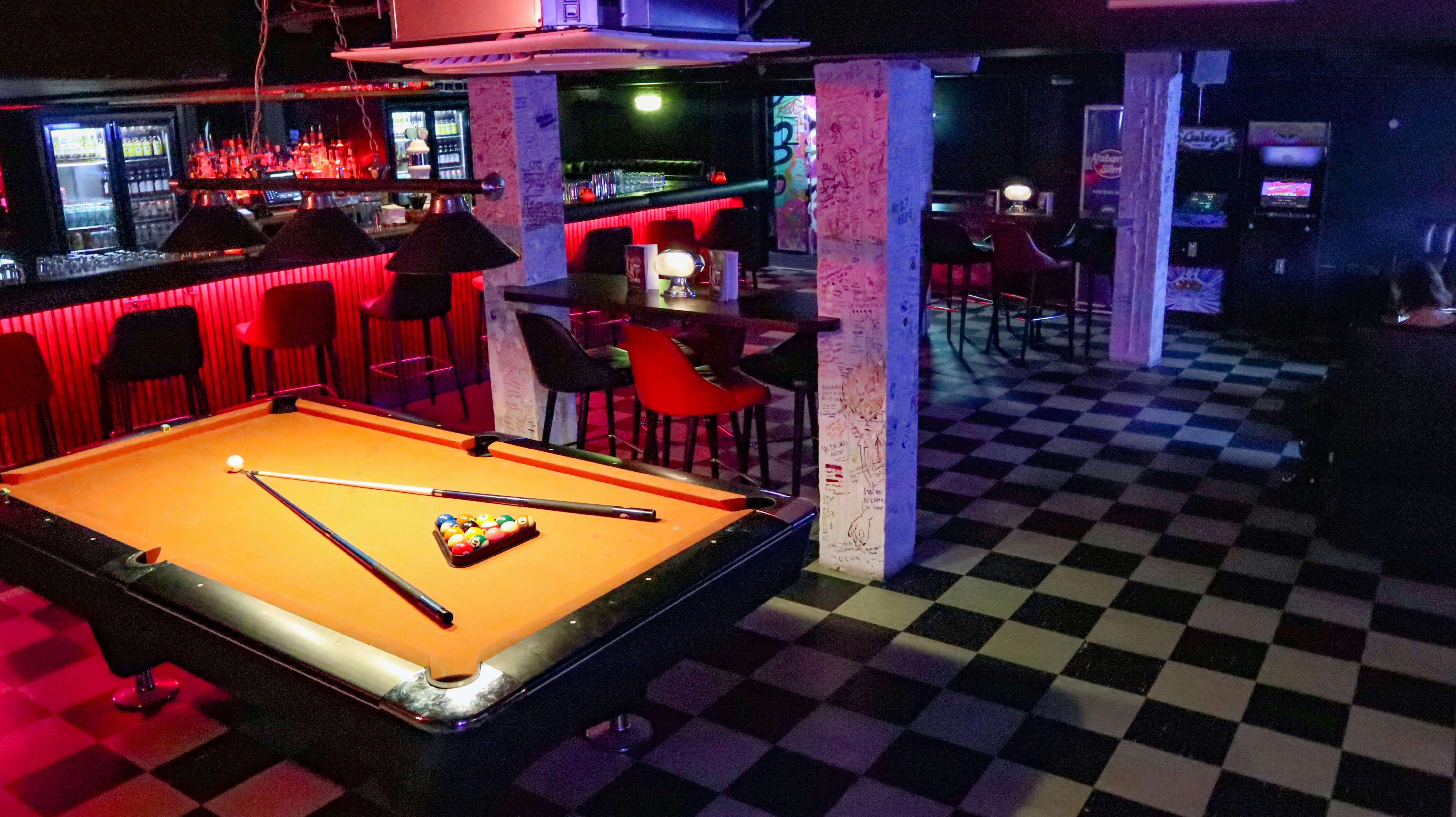 Vibrant event space with pool table at Salt Dog Slims, perfect for networking and gatherings.