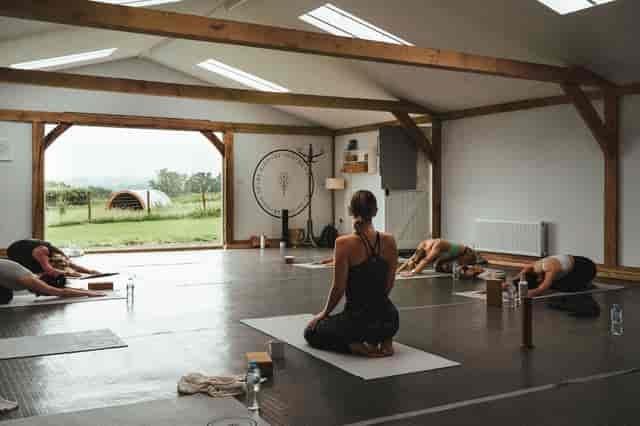 Serene yoga session in bright studio at Fair Oak Farm for wellness retreats and team-building.
