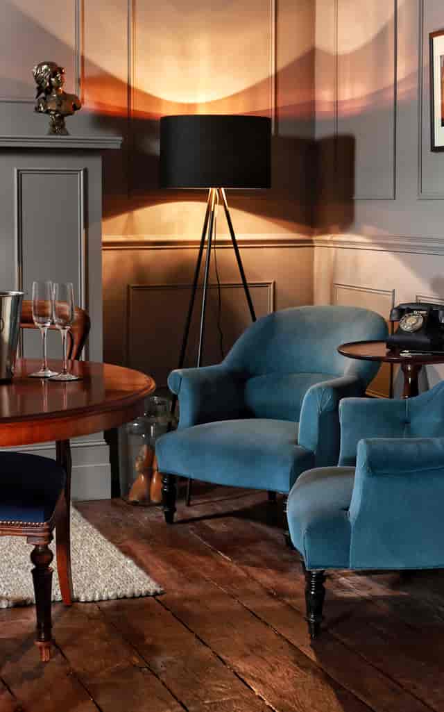 Stylish meeting space with plush blue chairs for private retreats and events.