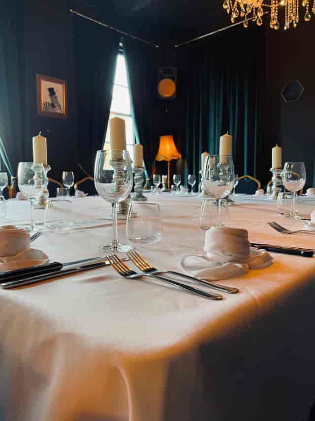 Elegant dining table with white linens for formal events at The Imperial Arms Lounge.
