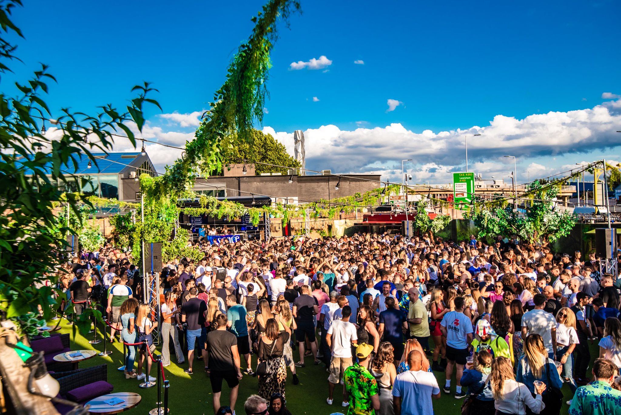 Vibrant outdoor event at Studio 338 with lush greenery, ideal for festivals and networking. - Banner