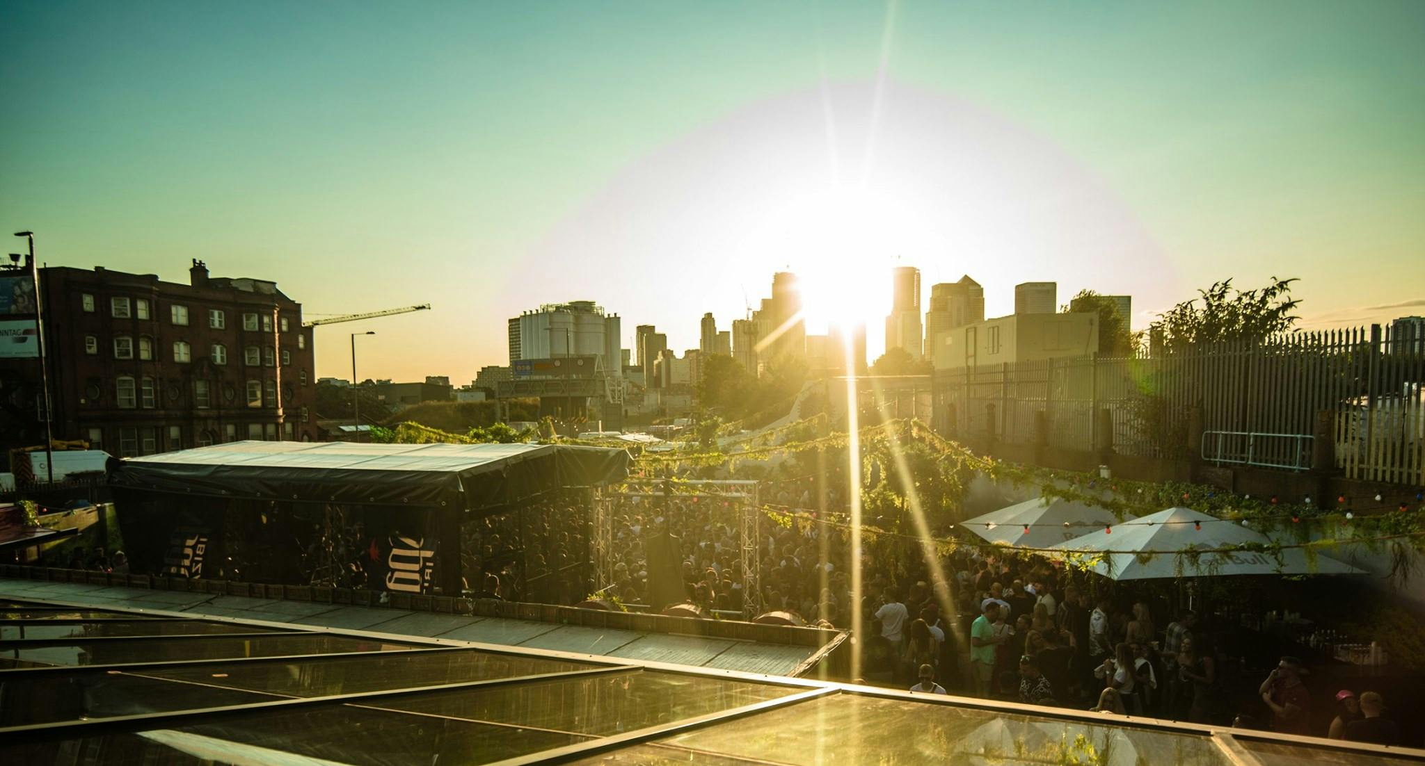 Vibrant outdoor event space at Studio 338 with sunset backdrop, ideal for gatherings.