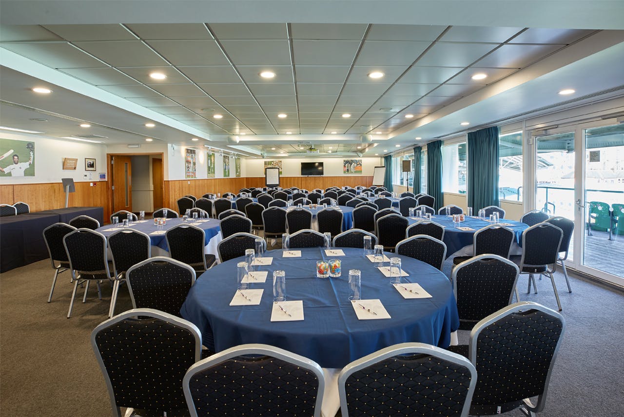 India Room at Kia Oval: spacious meeting space with blue tables for workshops and conferences.