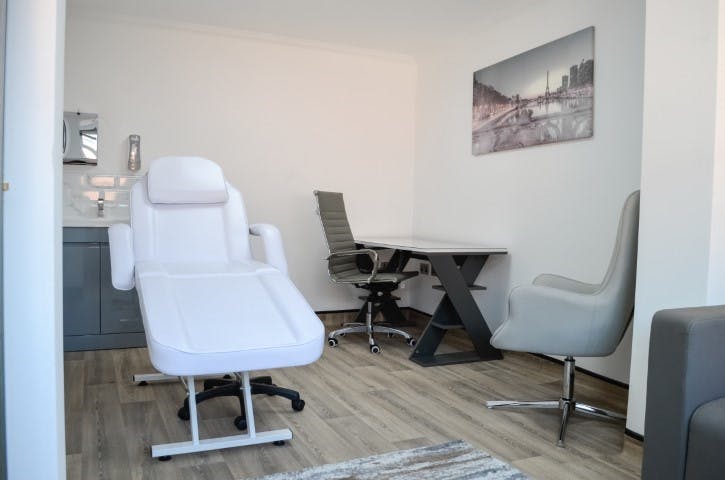 Modern minimalist treatment room at Best Health Suites for wellness events and consultations.
