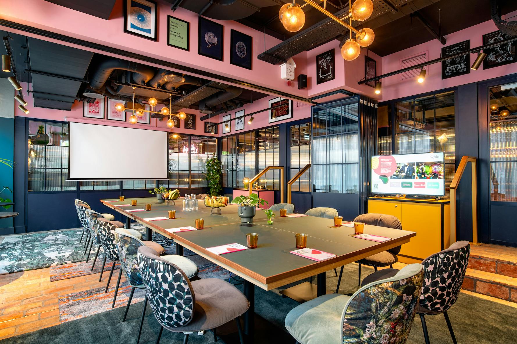 Stylish meeting room at Yotel Manchester with colorful decor for creative workshops.