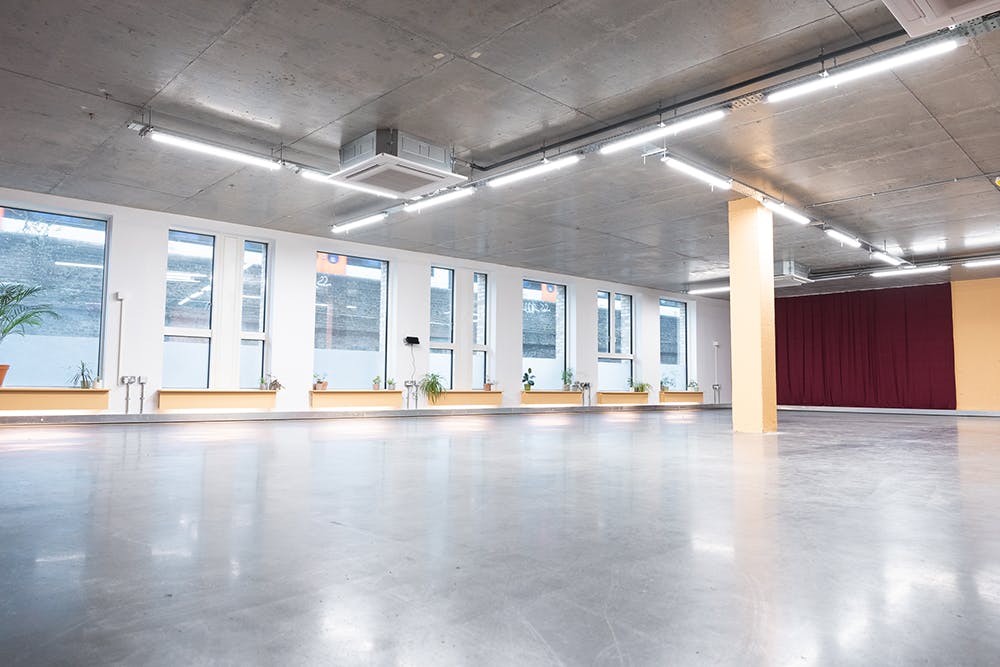 Versatile event space with natural light, ideal for workshops and networking events.