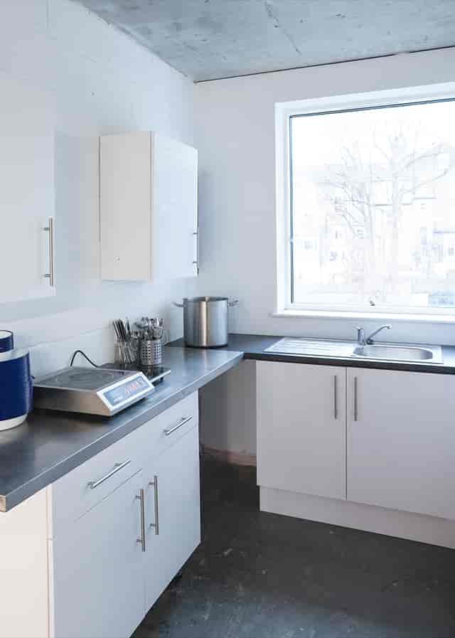 Modern kitchen with stainless steel surfaces, ideal for catering events and food preparation.