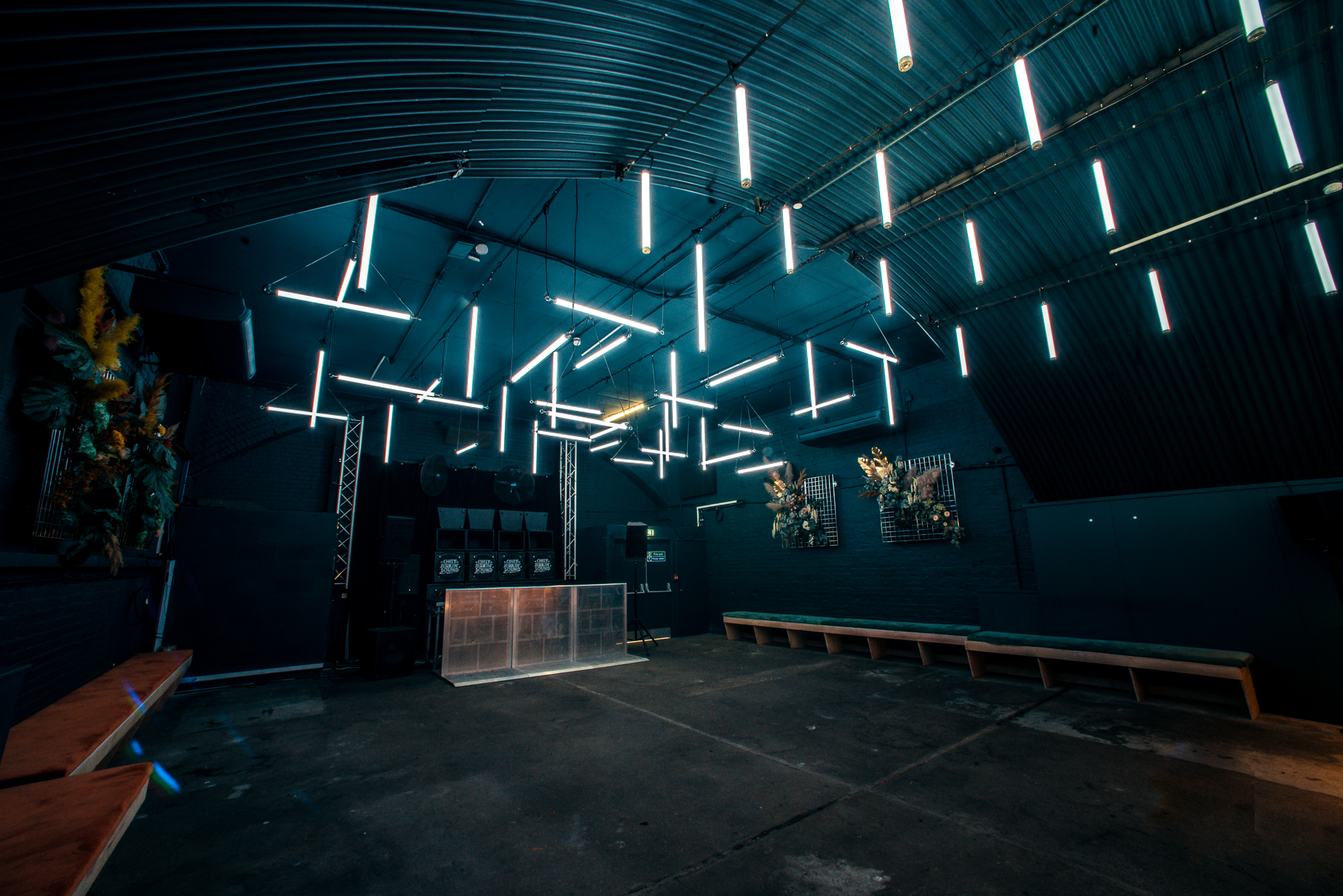 Modern industrial event space with linear lighting for gatherings and celebrations. - Banner