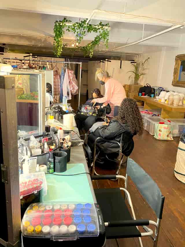 Behind-the-scenes event setup at 4th Floor Studios with hair and makeup tools.