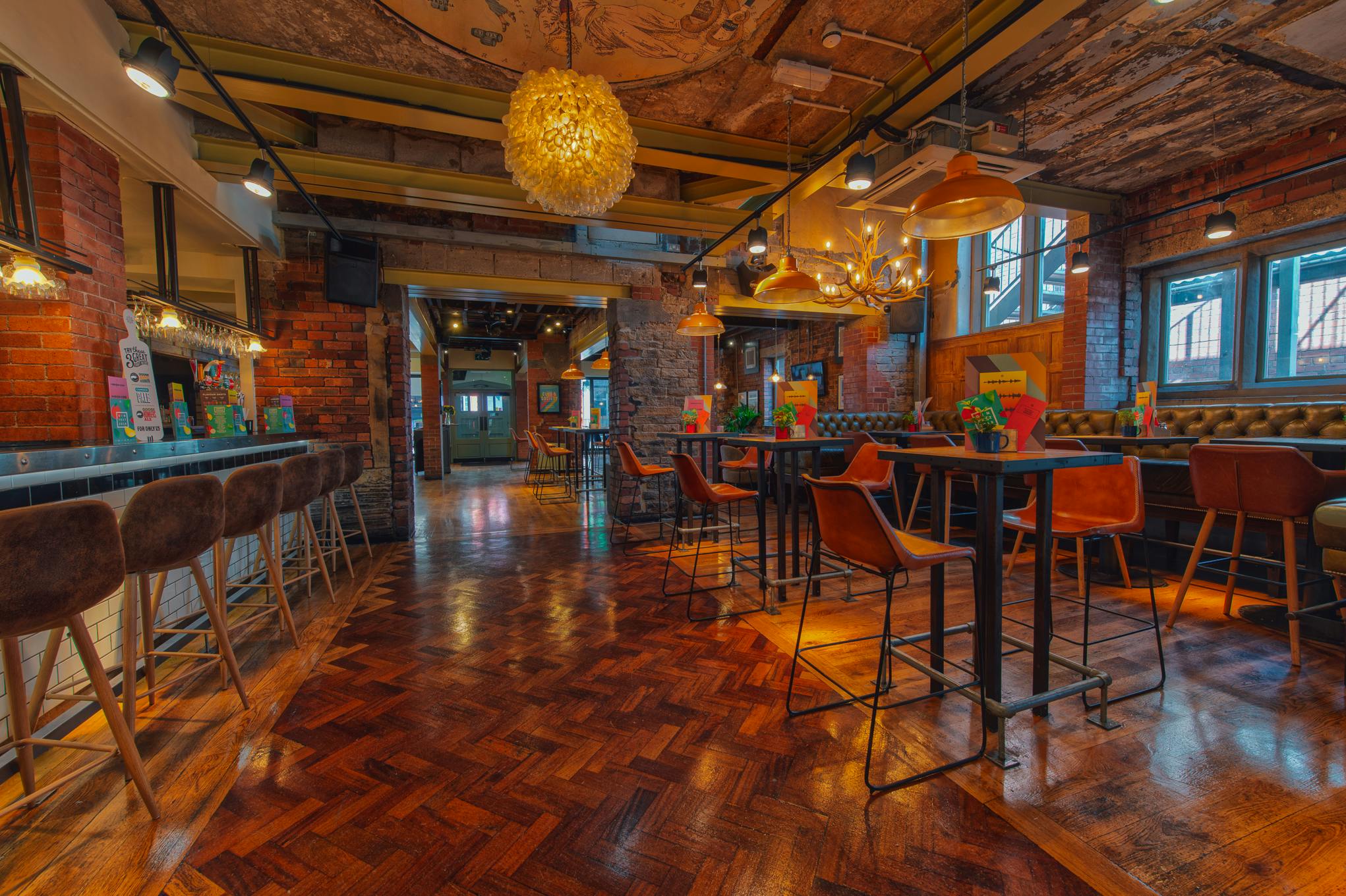 Stylish venue hire in Revolution Huddersfield with exposed brick walls for events.