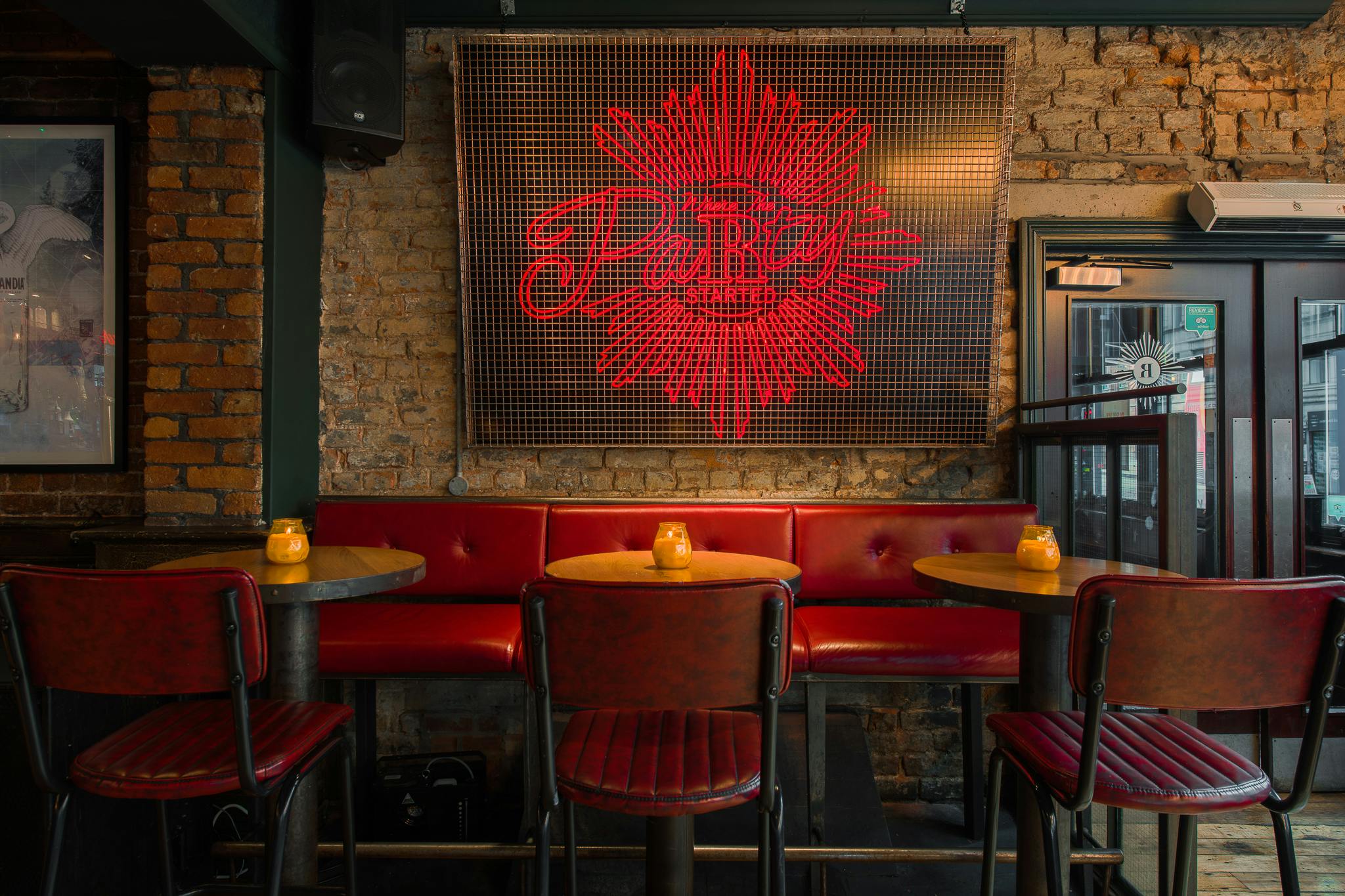 Stylish venue with red leather seating for intimate gatherings in Manchester.