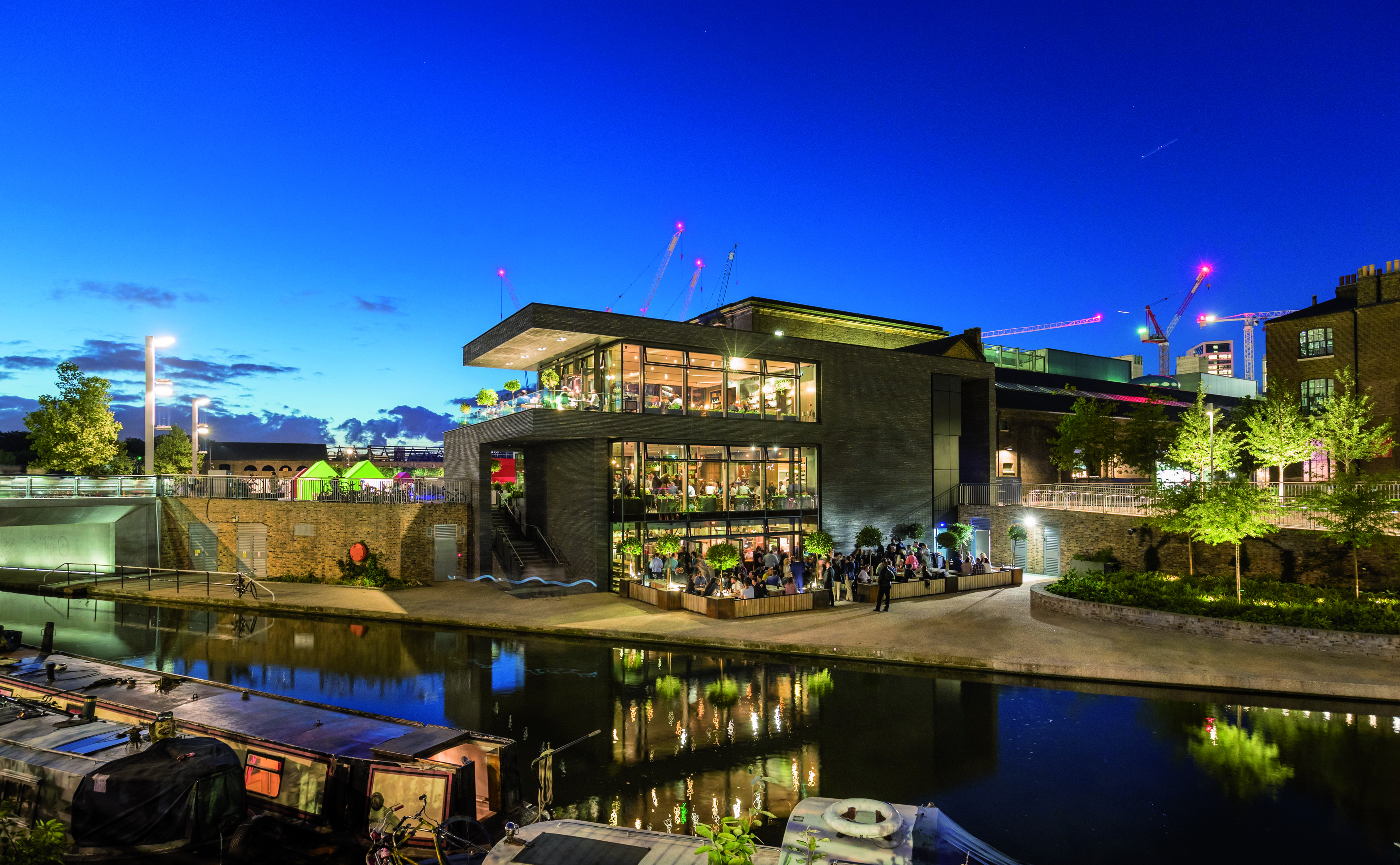 Stylish waterfront event venue with large windows, ideal for gatherings and receptions. - Banner