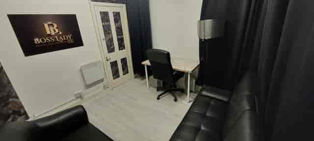 Minimalist meeting space with desk and chair for intimate discussions or consultations.