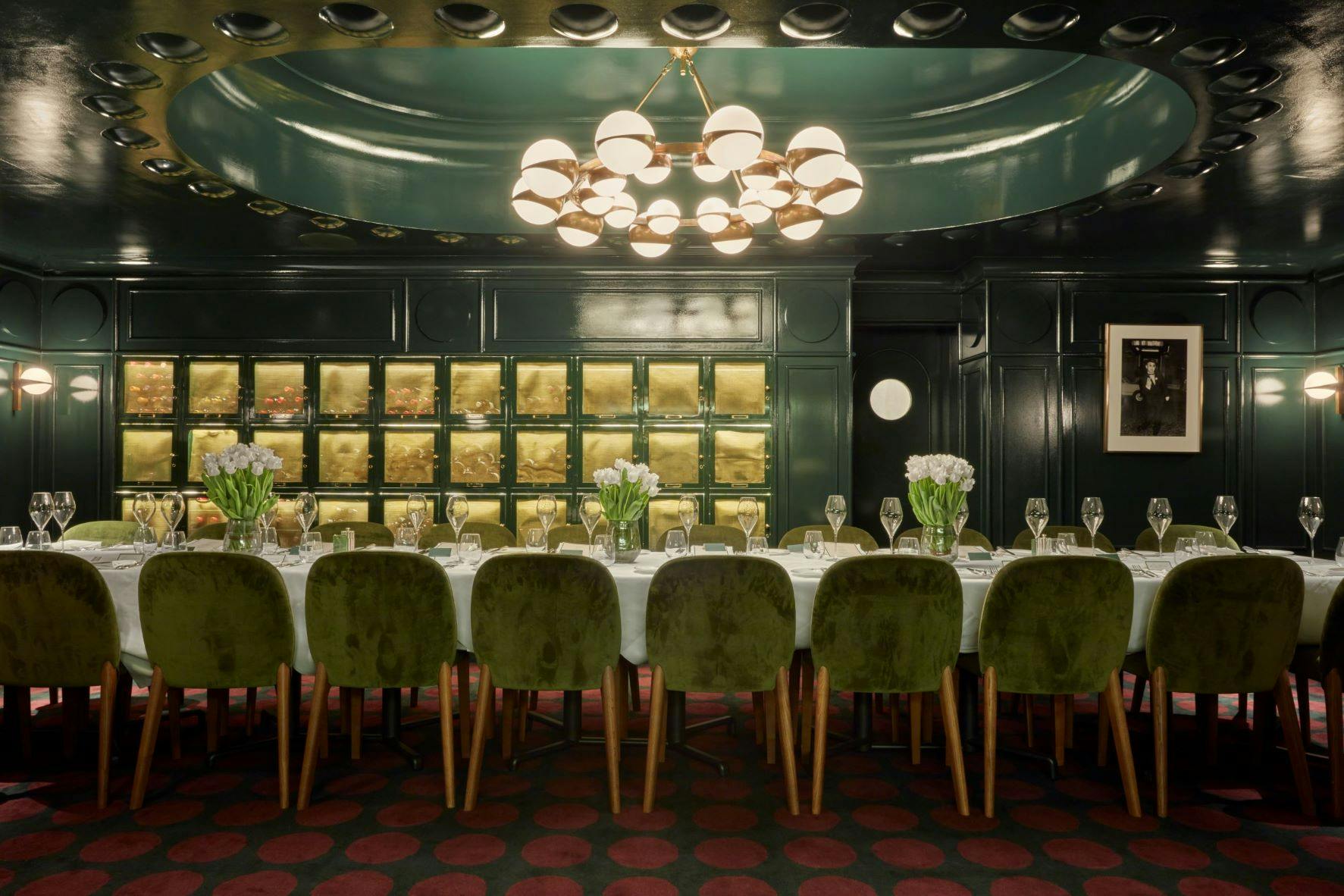 Elegant private dining room with green walls, ideal for corporate events and intimate gatherings.