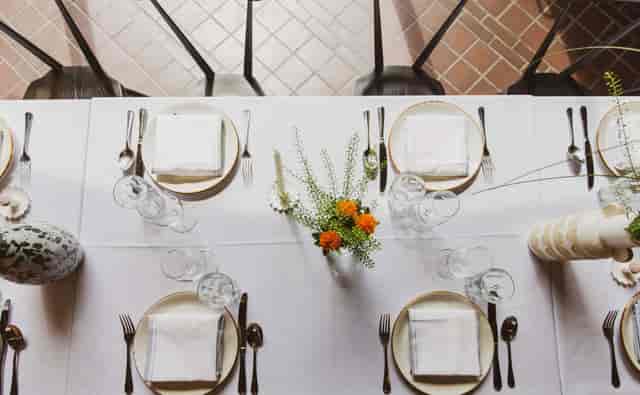 Elegant dining table setup with floral centerpiece for formal events at Ducie Street Warehouse.