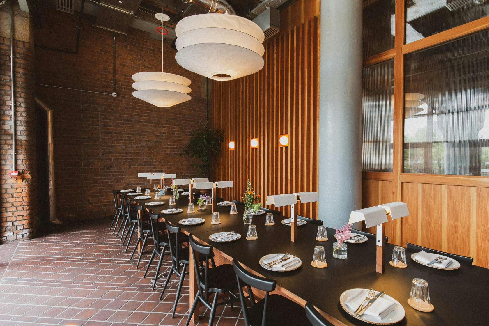 Modern dining space with warm brick walls for corporate dinners and workshops.