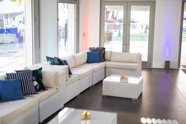 Stylish lounge area with white sectional sofa at The Reveller, Tower of London events.