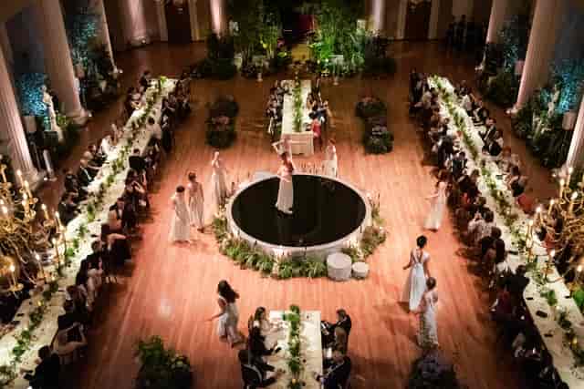 Elegant gala event at Banqueting House with lush decor and central stage for performances.