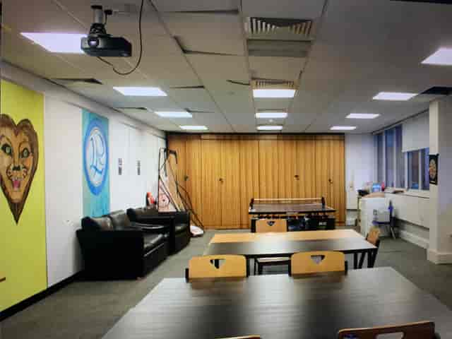 Versatile meeting space with colorful art, ideal for events and workshops in London.