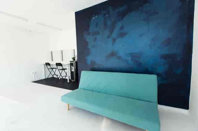 Studio A green room with vanity and lounge seating for VIP talent prep and production meetings.