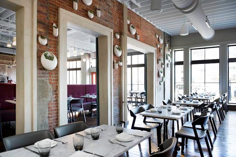 Private dining room in SRV Boston with exposed brick, perfect for events and gatherings.