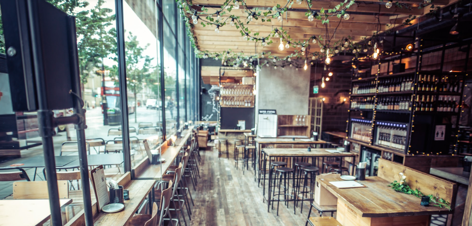 Royal box in Vagabond Victoria, modern venue with wooden tables for meetings and events. - Banner