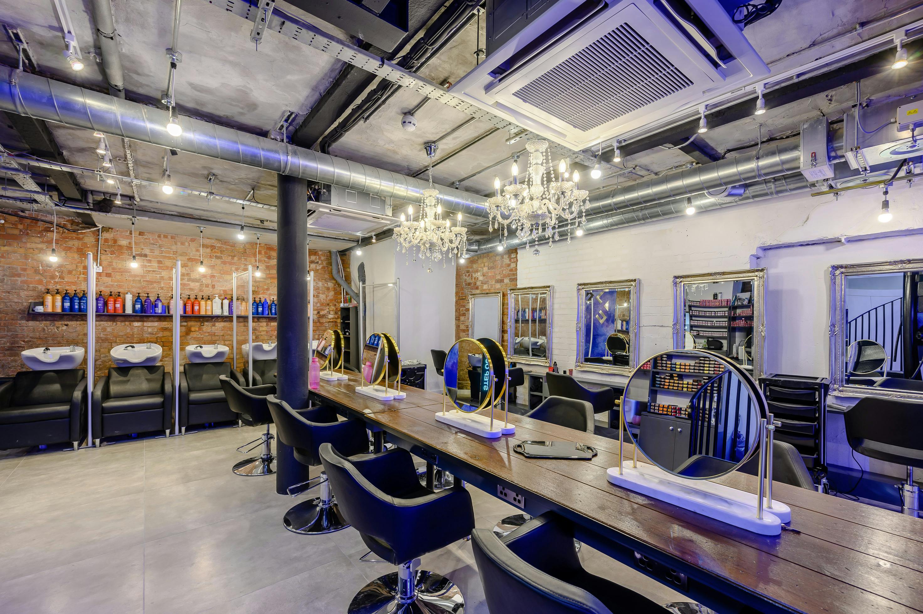 Modern salon space with sleek styling stations for beauty events and workshops.