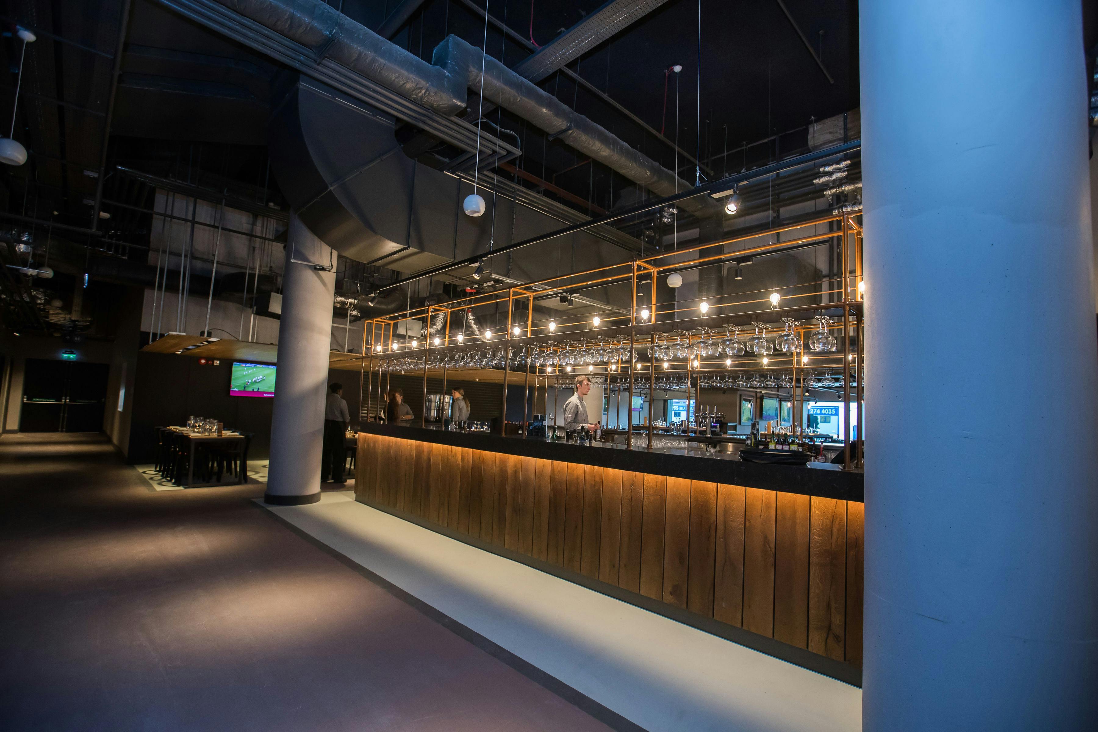 Modern event space at Allianz Stadium, Twickenham with sleek bar for networking events.