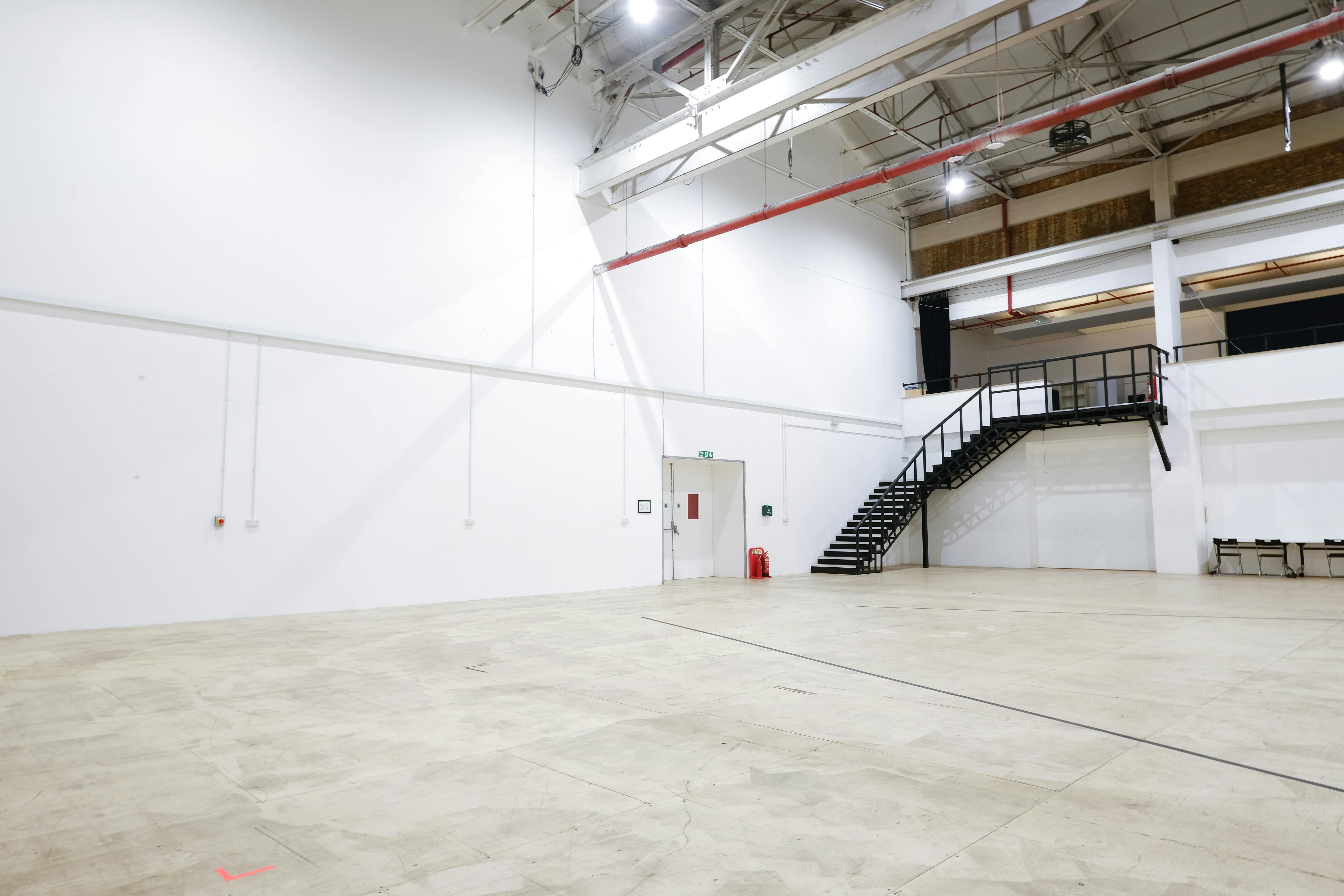 Spacious event venue with high ceilings for exhibitions and corporate events in Sugar Studios.