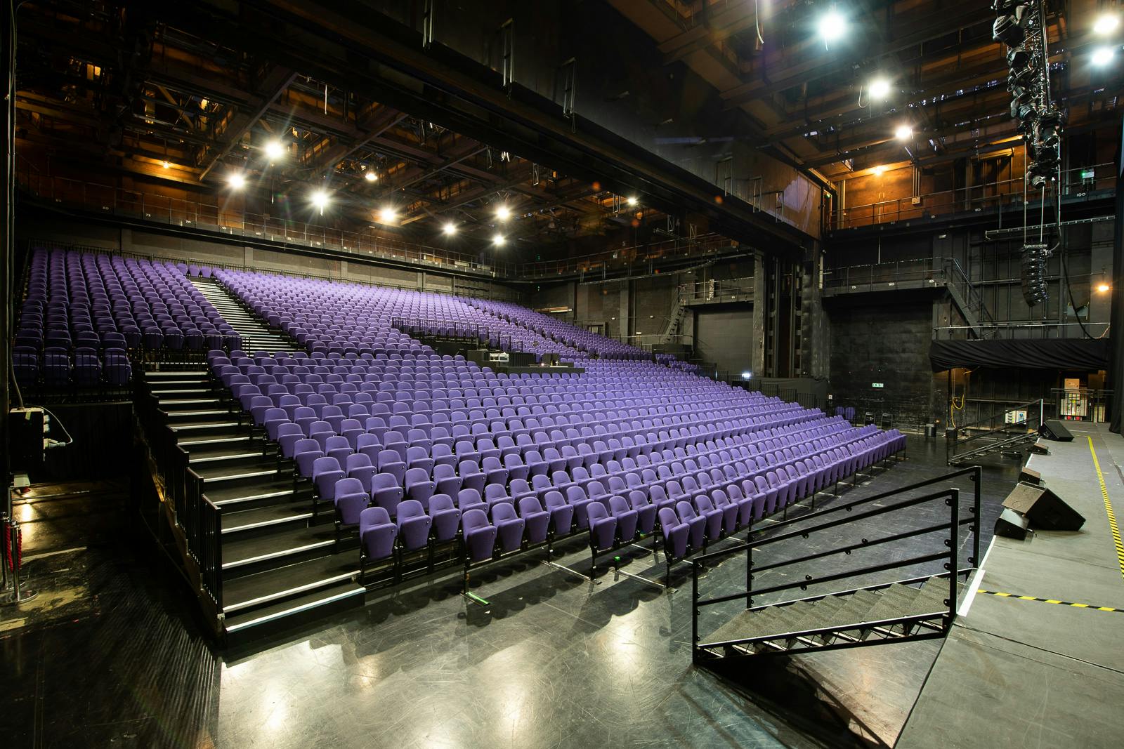 Troubadour Wembley Park Theatre auditorium with vibrant purple chairs for events.