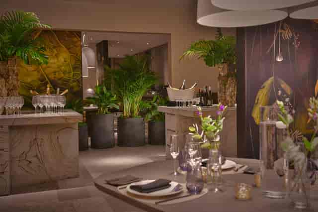 Elegant event space in Straits Kitchen, featuring lush greenery for upscale gatherings.