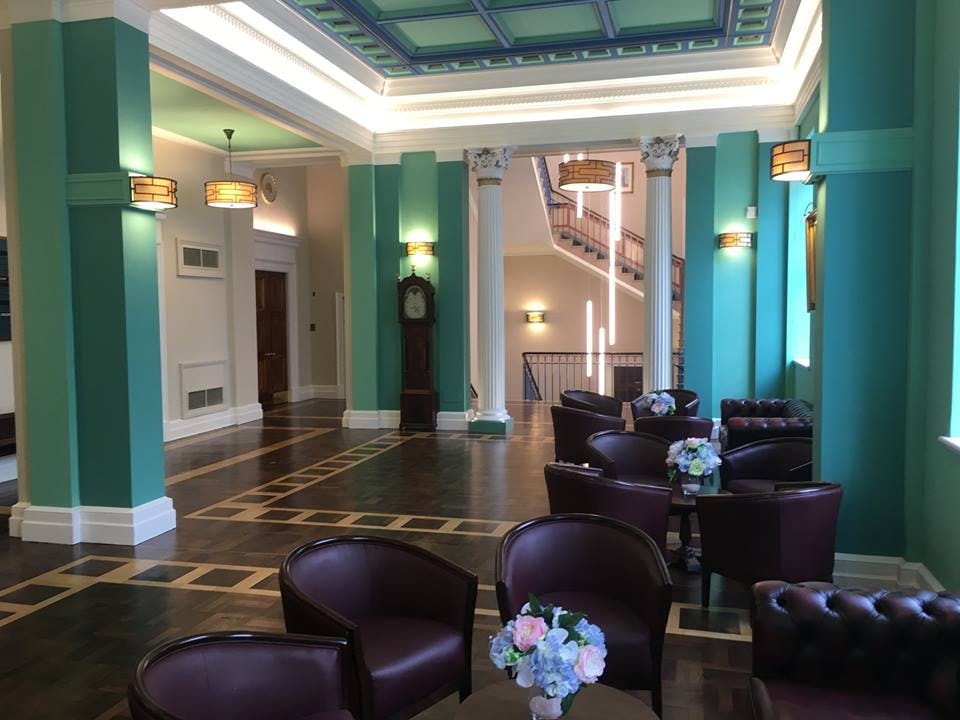 Elegant event space with teal walls, perfect for meetings and receptions at 17 Park Street.