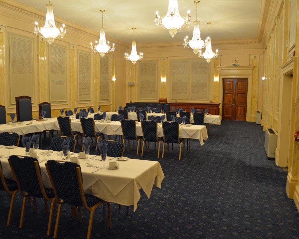 Elegant meeting room with chandeliers, ideal for corporate events and formal gatherings.