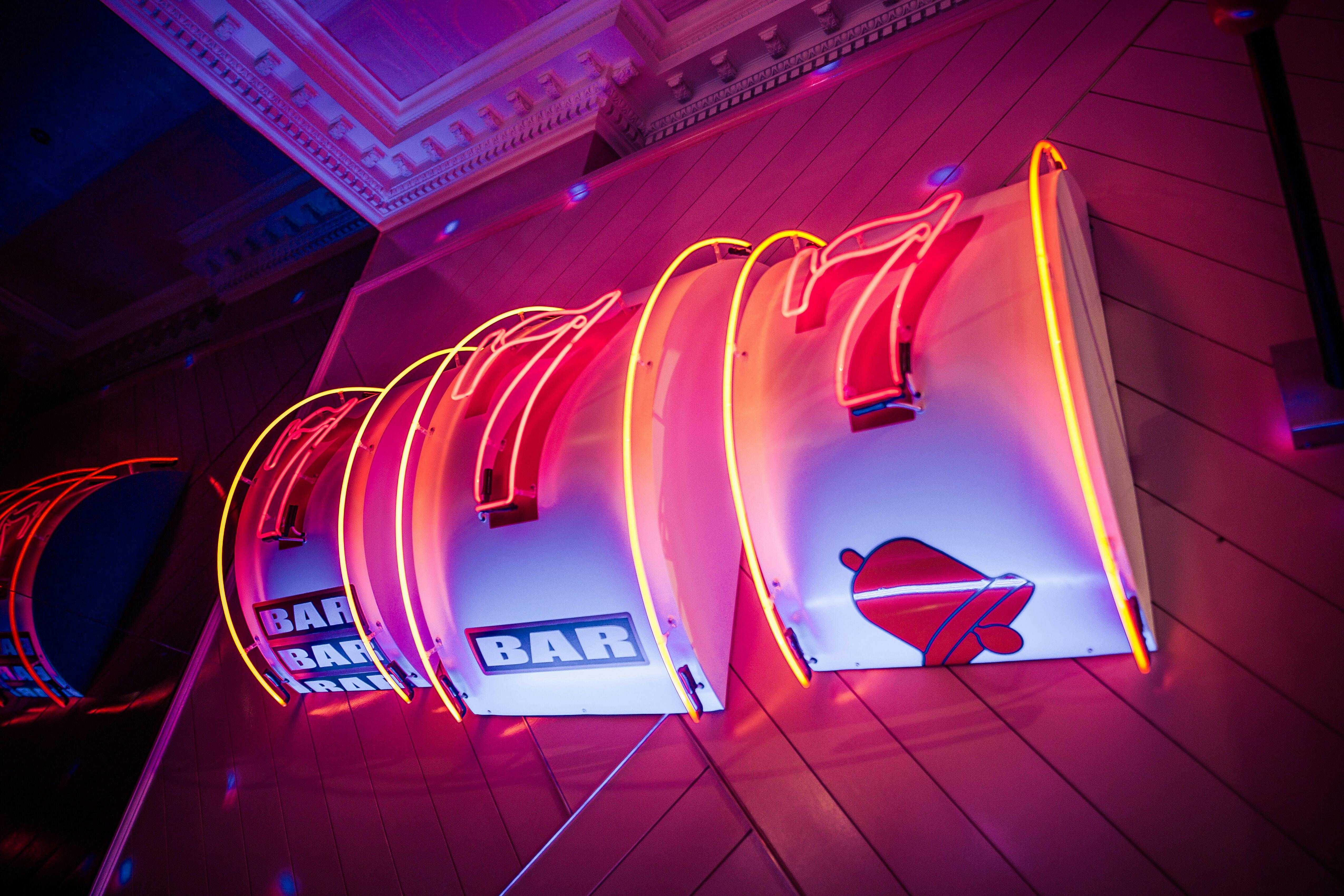 Vibrant neon bar sign at Simmons Bank Mezzanine for networking events and socializing.