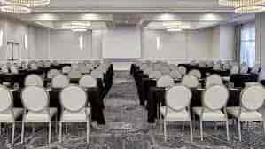 Chesapeake Ballroom: elegant meeting space with black tables, ideal for conferences and workshops.