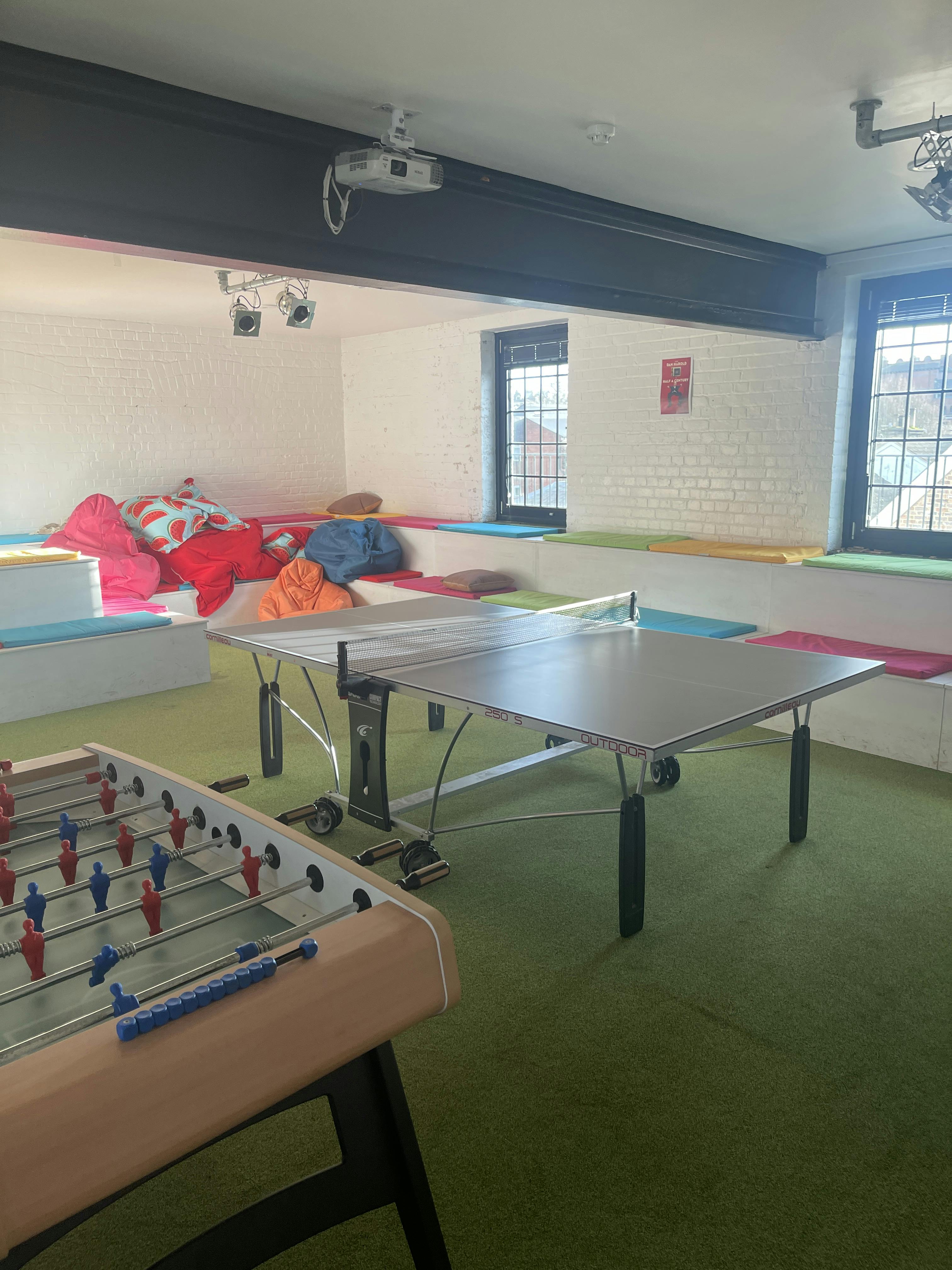 Vibrant HQ1 meeting space with ping pong table for creative team collaboration.